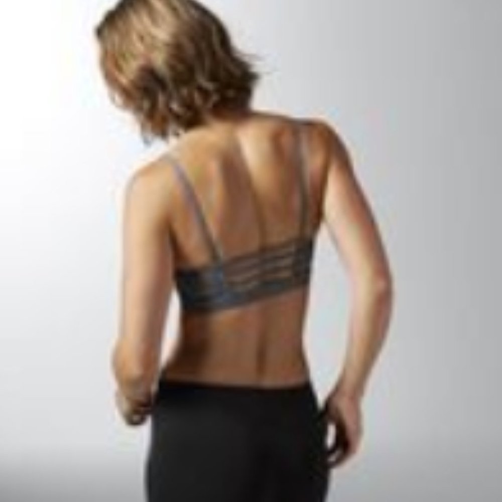 Two strappy back Reebok Hero Rebel sports bras / bralettes